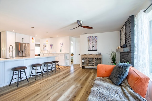 27071 Crews Hill Dr, Menifee, CA 92586 - living area with light wood-style flooring, ceiling fan, a brick fireplace, and recessed lighting