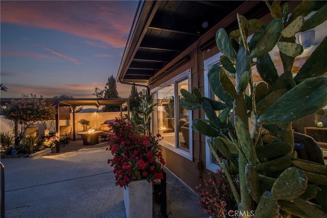 27071 Crews Hill Dr, Menifee, CA 92586 - patio terrace at dusk featuring a patio and an outdoor fire pit
