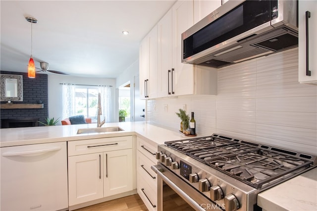 27071 Crews Hill Dr, Menifee, CA 92586 - kitchen with appliances with stainless steel finishes, a sink, light countertops, and white cabinetry