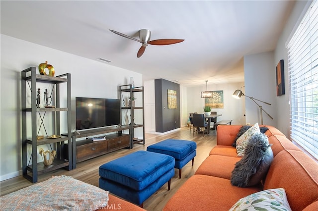 27071 Crews Hill Dr, Menifee, CA 92586 - living room featuring a ceiling fan, wood finished floors, baseboards, and a chandelier