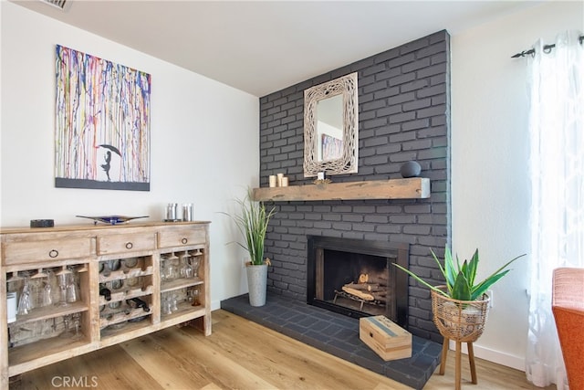 27071 Crews Hill Dr, Menifee, CA 92586 - living area featuring wood finished floors and a brick fireplace