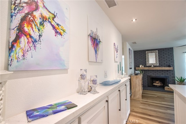 27071 Crews Hill Dr, Menifee, CA 92586 - bathroom featuring a fireplace, wood finished floors, and vanity