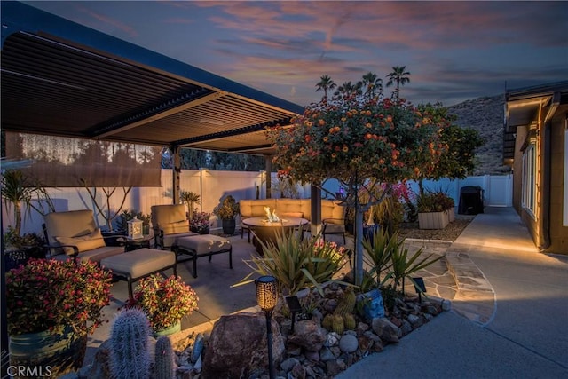 27071 Crews Hill Dr, Menifee, CA 92586 - patio terrace at dusk with outdoor lounge area, a patio area, a fenced backyard, and a pergola