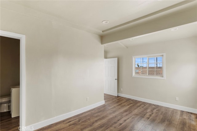 10010 S San Pedro St, Los Angeles, CA 90003 - unfurnished room with wood finished floors, baseboards, and beam ceiling