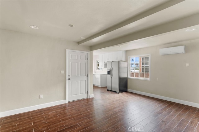 10010 S San Pedro St, Los Angeles, CA 90003 - unfurnished living room with a wall unit AC, baseboards, and dark wood-style flooring