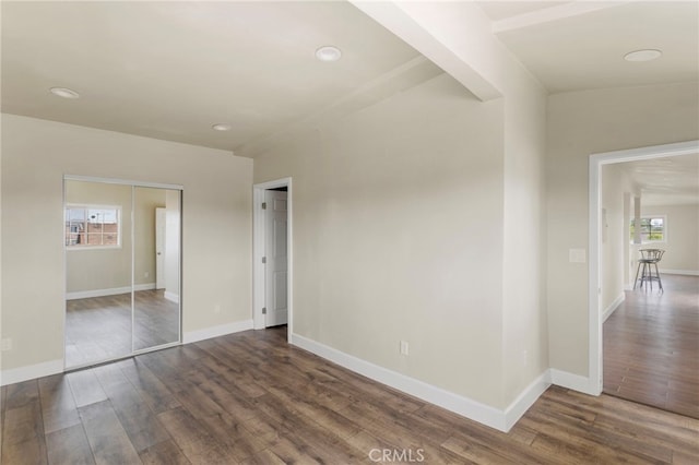 10010 S San Pedro St, Los Angeles, CA 90003 - unfurnished bedroom featuring dark wood-type flooring, baseboards, a closet, and recessed lighting