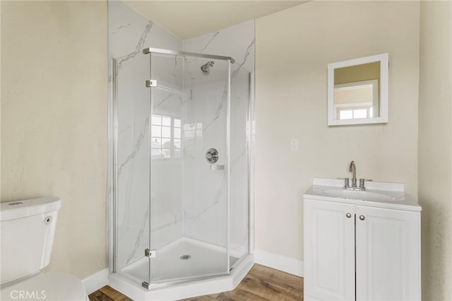 10010 S San Pedro St, Los Angeles, CA 90003 - bathroom with a marble finish shower, toilet, vanity, wood finished floors, and baseboards