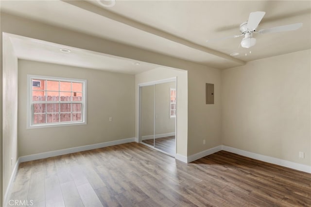 10010 S San Pedro St, Los Angeles, CA 90003 - spare room with electric panel, baseboards, and wood finished floors