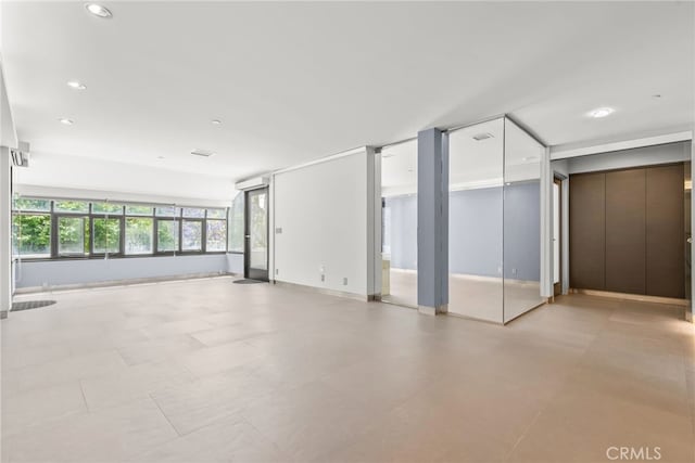 121 S Hope St Unit 9, Los Angeles, CA 90012 - unfurnished room with recessed lighting, baseboards, and elevator