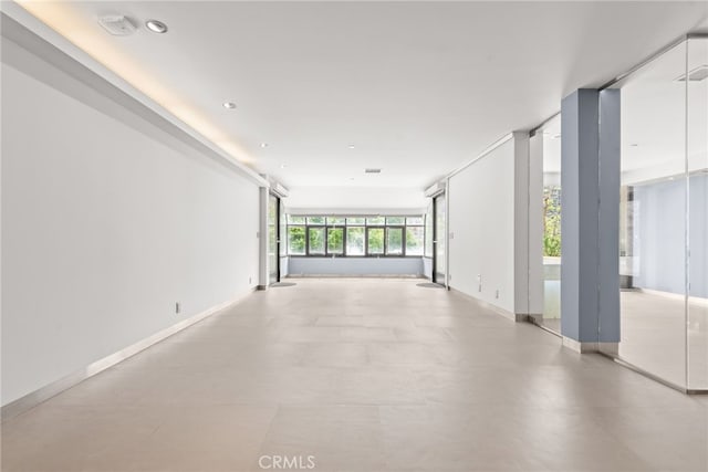121 S Hope St Unit 9, Los Angeles, CA 90012 - empty room with baseboards and recessed lighting