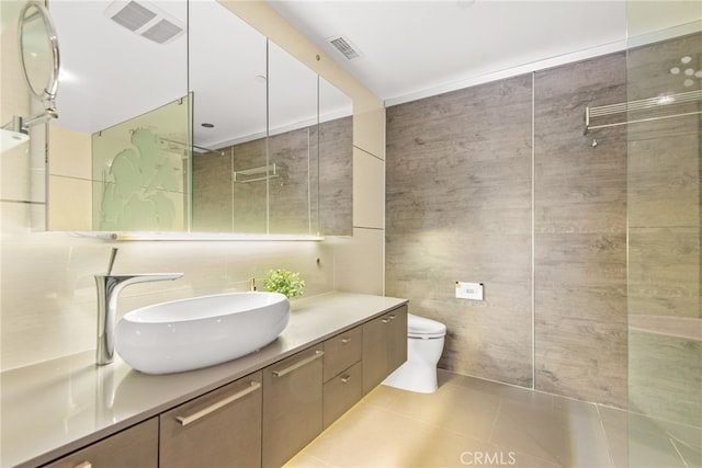 121 S Hope St Unit 9, Los Angeles, CA 90012 - full bath featuring tile walls, vanity, tile patterned flooring, and toilet