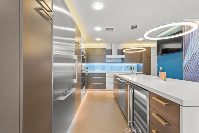 121 S Hope St Unit 9, Los Angeles, CA 90012 - kitchen with beverage cooler, modern cabinets, light countertops, a sink, and decorative backsplash