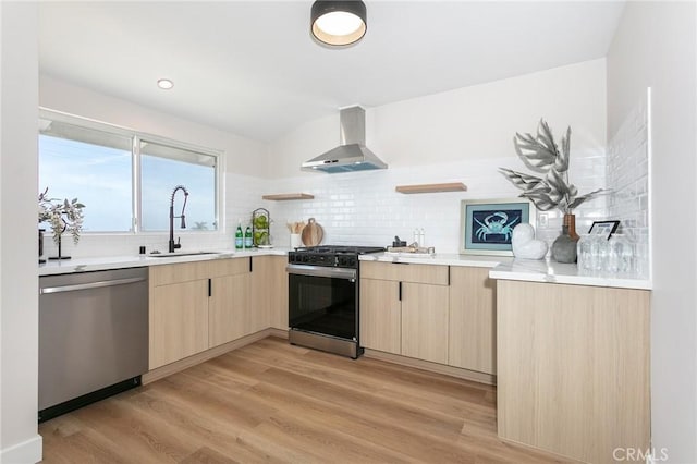 2145 Mcrae Dr, San Pedro, CA 90732 - kitchen with appliances with stainless steel finishes, wall chimney range hood, light brown cabinetry, and a sink