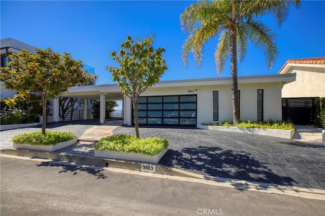 3863 Sherwood Pl, Sherman Oaks, CA 91423 - view of front of home featuring stucco siding, a garage, and driveway