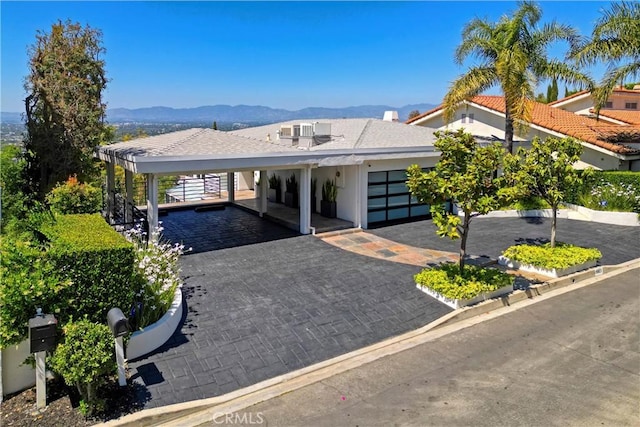 3863 Sherwood Pl, Sherman Oaks, CA 91423 - view of front facade featuring a mountain view, a carport, and decorative driveway