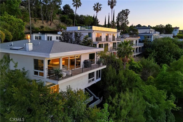 3863 Sherwood Pl, Sherman Oaks, CA 91423 - rear view of property featuring stucco siding, a balcony, and a shingled roof