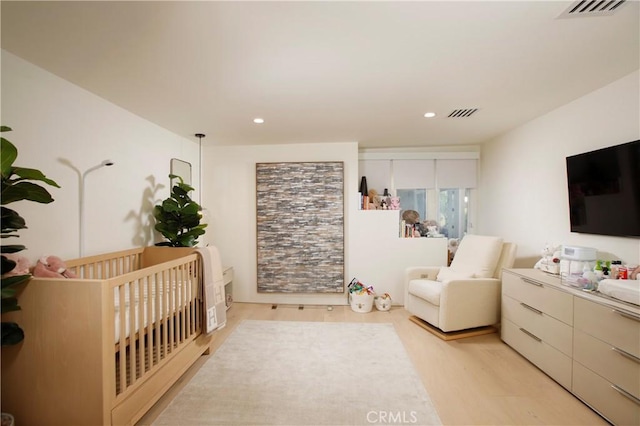 3863 Sherwood Pl, Sherman Oaks, CA 91423 - bedroom with light wood-style flooring, a crib, and recessed lighting