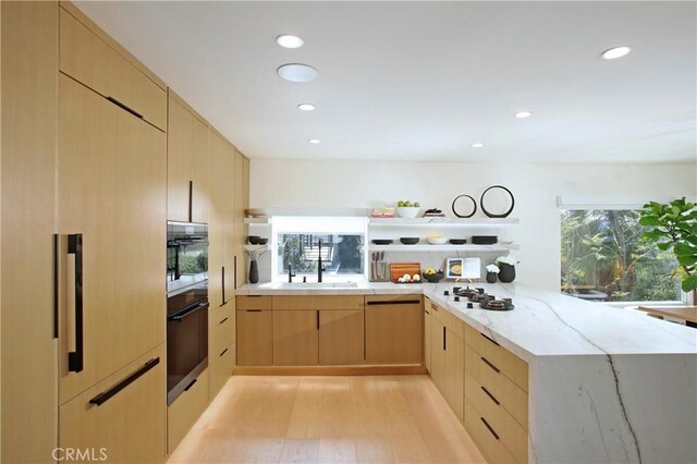 3863 Sherwood Pl, Sherman Oaks, CA 91423 - kitchen with light brown cabinetry, light stone counters, a sink, light wood finished floors, and recessed lighting