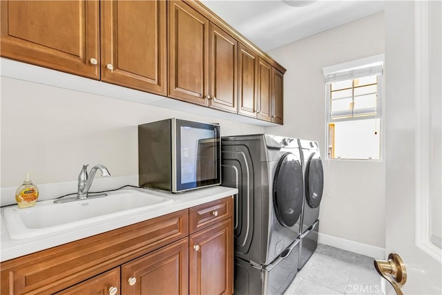 28181 Via Del Mar, San Juan Capistrano, CA 92675 - washroom with washer and clothes dryer, cabinet space, light tile patterned flooring, and baseboards