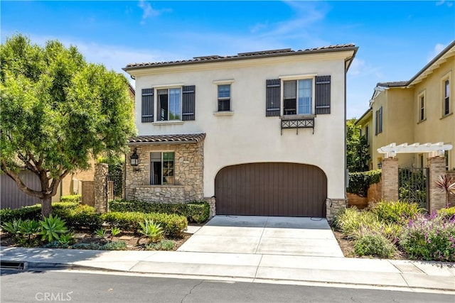 28181 Via Del Mar, San Juan Capistrano, CA 92675 - mediterranean / spanish house featuring a tile roof, an attached garage, stone siding, and stucco siding