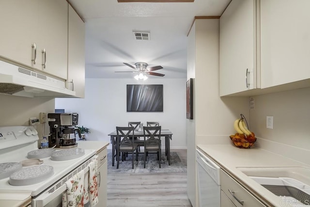 12158 Orange Crest Ct Unit 4, Lakeside, CA 92040 - kitchen featuring white appliances, under cabinet range hood, light countertops, light wood-type flooring, and a sink