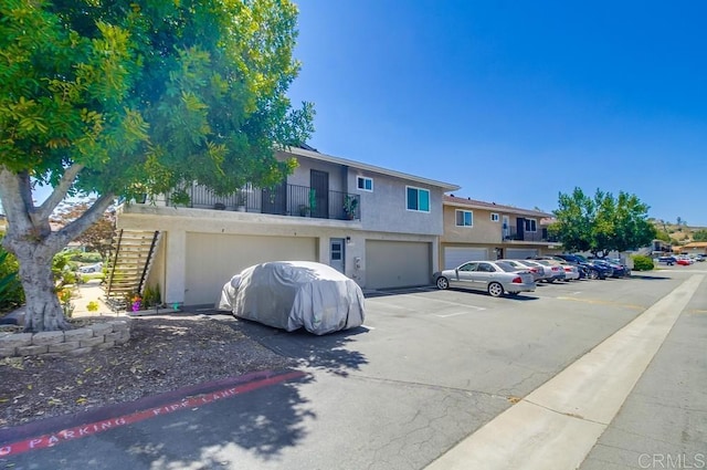12158 Orange Crest Ct Unit 4, Lakeside, CA 92040 - view of front facade featuring stairs, stucco siding, and an attached garage