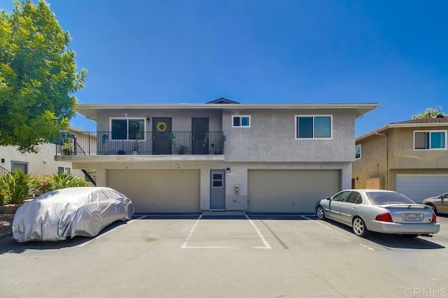 12158 Orange Crest Ct Unit 4, Lakeside, CA 92040 - view of property with a garage, stucco siding, and a balcony