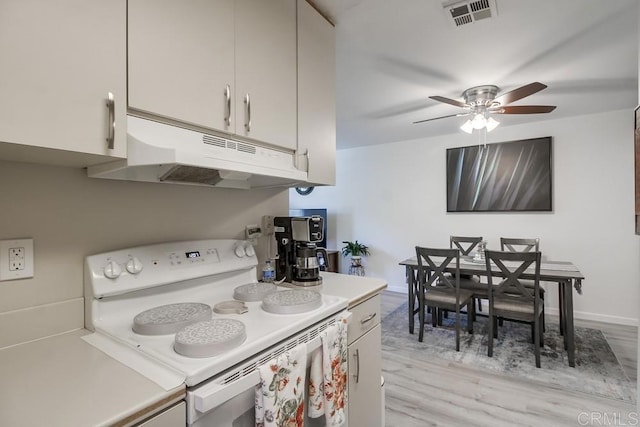 12158 Orange Crest Ct Unit 4, Lakeside, CA 92040 - kitchen featuring white range with electric cooktop, under cabinet range hood, light countertops, light wood-type flooring, and a ceiling fan