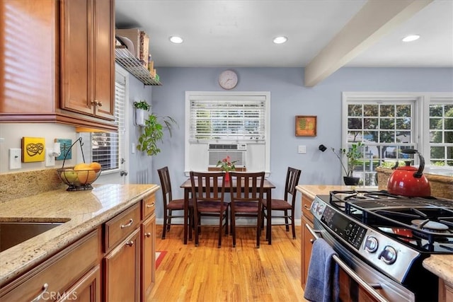 2515 Armour Ln, Redondo Beach, CA 90278 - kitchen featuring stainless steel range with gas stovetop, light wood-style flooring, brown cabinetry, cooling unit, and healthy amount of natural light