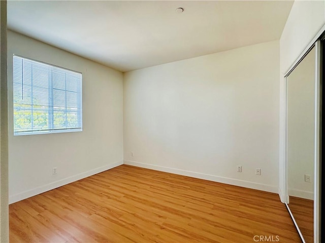 700 Meyer Ln, Redondo Beach, CA 90277 - unfurnished bedroom featuring light wood-style floors, baseboards, and a closet