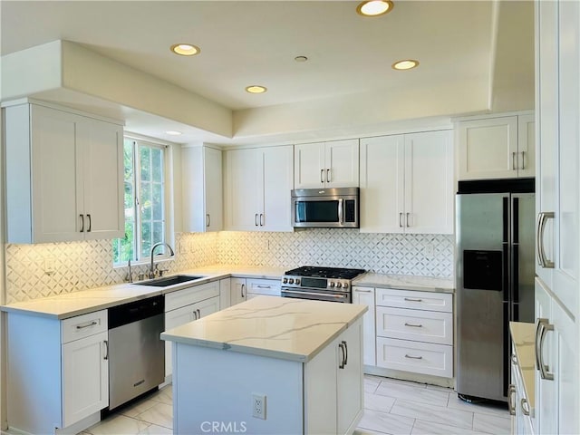 700 Meyer Ln, Redondo Beach, CA 90277 - kitchen featuring stainless steel appliances, a sink, a center island, light marble finish flooring, and light stone countertops