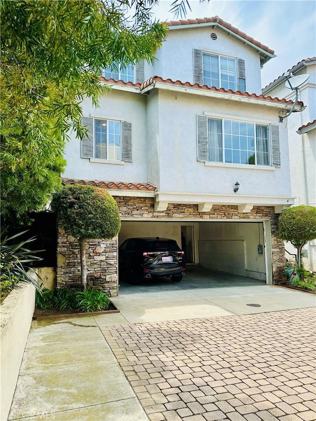 700 Meyer Ln, Redondo Beach, CA 90277 - mediterranean / spanish-style house featuring driveway, a garage, stone siding, stucco siding, and a tiled roof