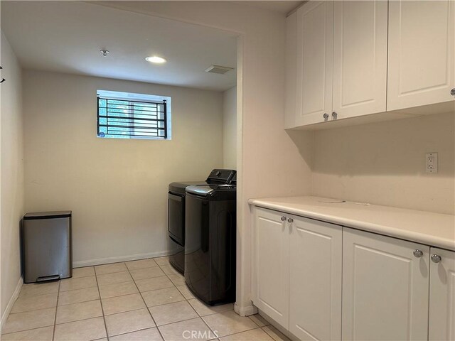 700 Meyer Ln, Redondo Beach, CA 90277 - laundry room featuring independent washer and dryer, cabinet space, baseboards, and light tile patterned flooring