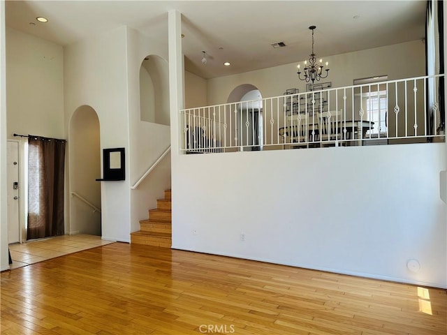 700 Meyer Ln, Redondo Beach, CA 90277 - empty room featuring wood-type flooring, a chandelier, arched walkways, and recessed lighting