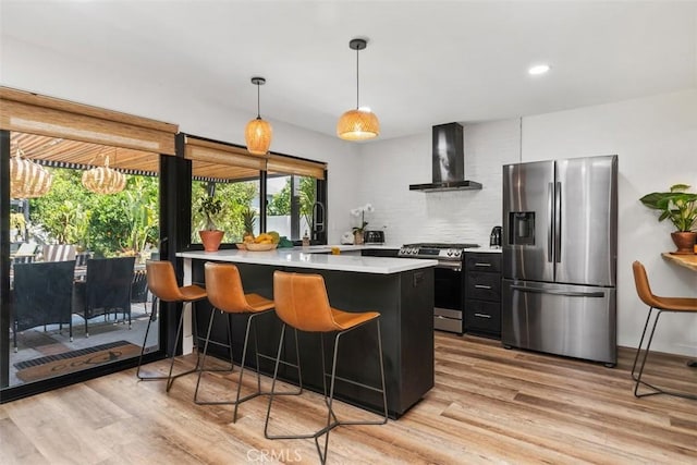 17630 Mapes Ave, Cerritos, CA 90703 - kitchen featuring stainless steel appliances, wall chimney exhaust hood, plenty of natural light, light wood-style floors, and recessed lighting