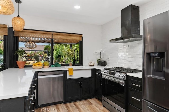 17630 Mapes Ave, Cerritos, CA 90703 - kitchen featuring stainless steel appliances, wall chimney exhaust hood, dark cabinets, light countertops, and a sink