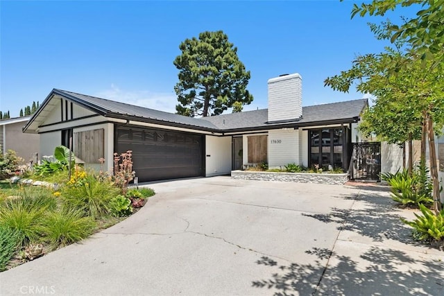 17630 Mapes Ave, Cerritos, CA 90703 - view of front of home featuring a garage, concrete driveway, and a chimney