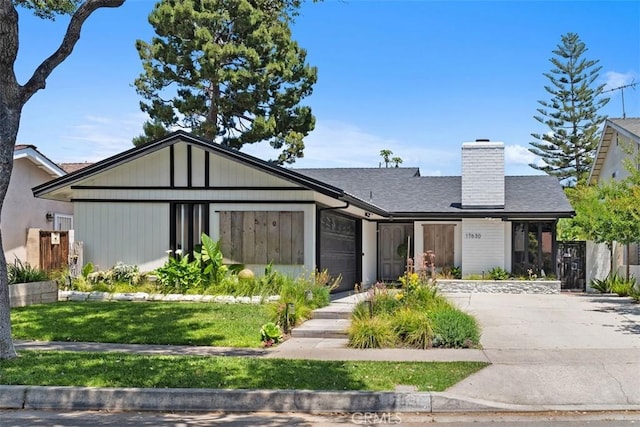 17630 Mapes Ave, Cerritos, CA 90703 - view of front of house with driveway, a chimney, an attached garage, a front yard, and roof with shingles