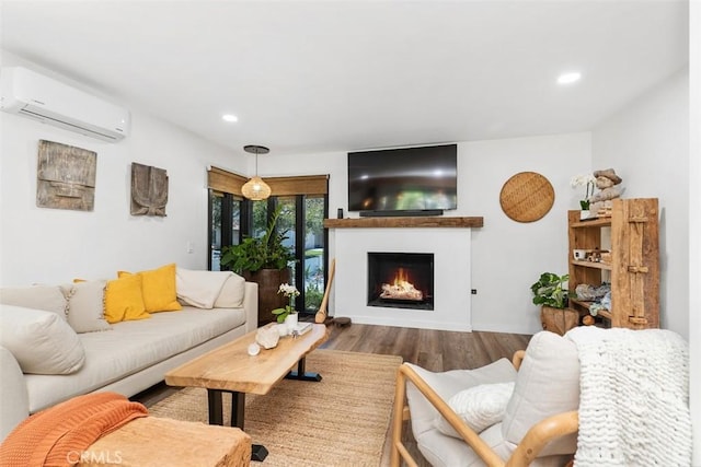 17630 Mapes Ave, Cerritos, CA 90703 - living room featuring a wall mounted AC, a warm lit fireplace, wood finished floors, and recessed lighting