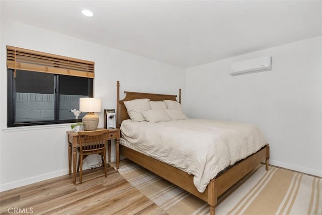 17630 Mapes Ave, Cerritos, CA 90703 - bedroom featuring a wall mounted AC, baseboards, wood finished floors, and recessed lighting