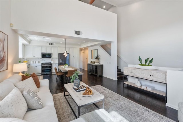 5547 Strand Unit 101, Hawthorne, CA 90250 - living area with stairway, dark wood-style floors, recessed lighting, crown molding, and baseboards