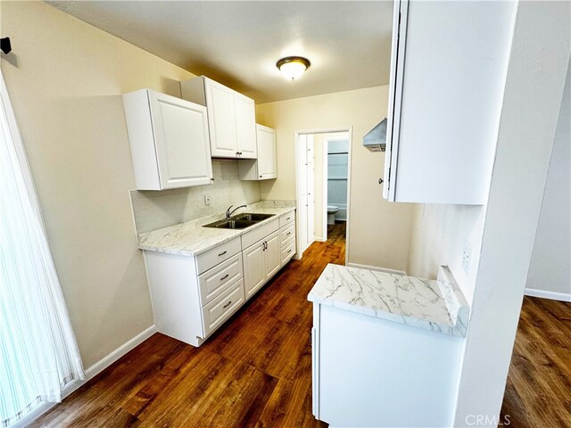 1850 Gardenia Ave, Long Beach, CA 90806 - kitchen featuring a sink, dark wood-style floors, baseboards, and white cabinetry