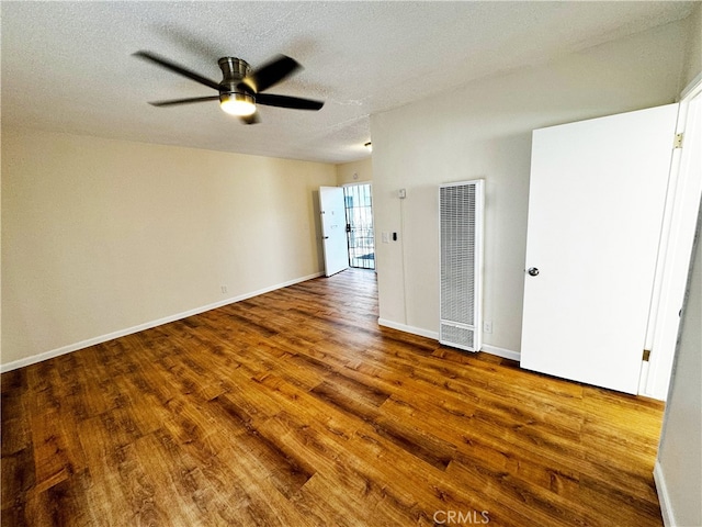 1850 Gardenia Ave, Long Beach, CA 90806 - unfurnished bedroom with a heating unit, wood finished floors, a textured ceiling, baseboards, and a ceiling fan