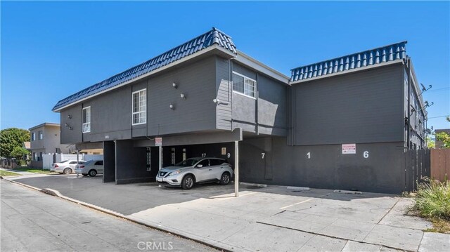 1850 Gardenia Ave, Long Beach, CA 90806 - view of building exterior featuring covered and uncovered parking