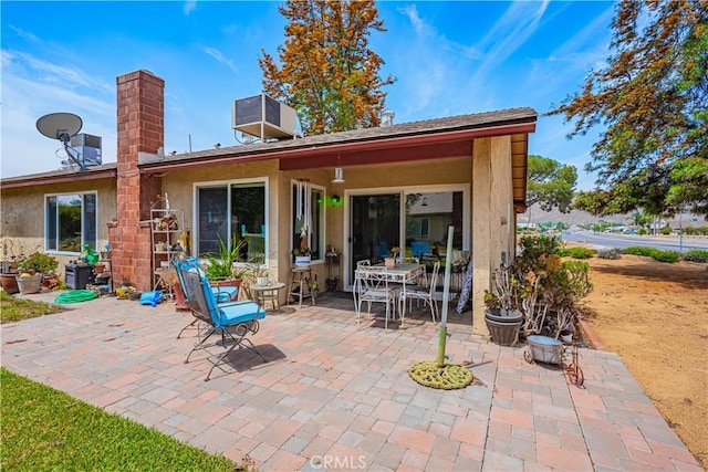 28030 Northwood Dr, Menifee, CA 92586 - rear view of property featuring stucco siding, a patio, a chimney, and outdoor dining space