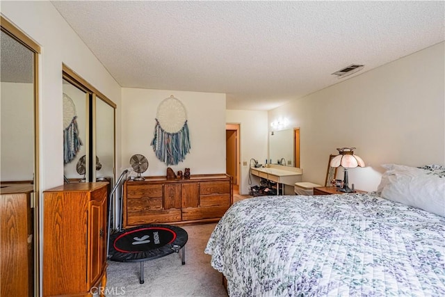 28030 Northwood Dr, Menifee, CA 92586 - bedroom with carpet, a textured ceiling, and two closets