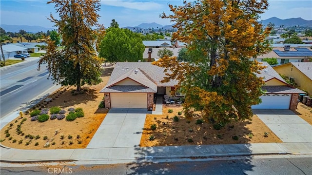 28030 Northwood Dr, Menifee, CA 92586 - view of property hidden behind natural elements featuring concrete driveway, a mountain view, and brick siding
