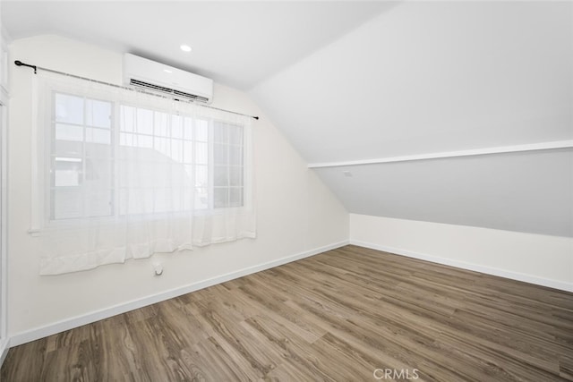 6082 Bannock Rd, Westminster, CA 92683 - bonus room with a wall mounted air conditioner, lofted ceiling, wood finished floors, and baseboards