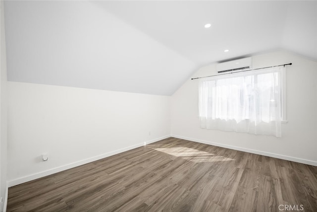 6082 Bannock Rd, Westminster, CA 92683 - bonus room with an AC wall unit, vaulted ceiling, wood finished floors, and baseboards