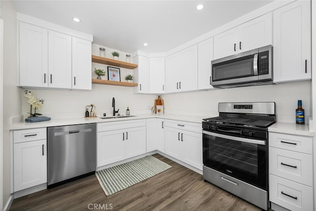 6082 Bannock Rd, Westminster, CA 92683 - kitchen featuring appliances with stainless steel finishes, a sink, dark wood finished floors, white cabinets, and recessed lighting
